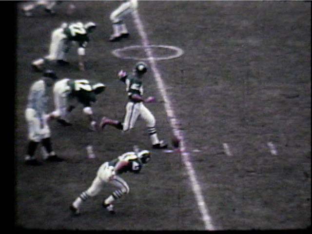 Dick Kenney #42 kicks off with his bare foot, 1966