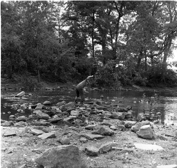 Woman feeds ducks on the Red Cedar River
