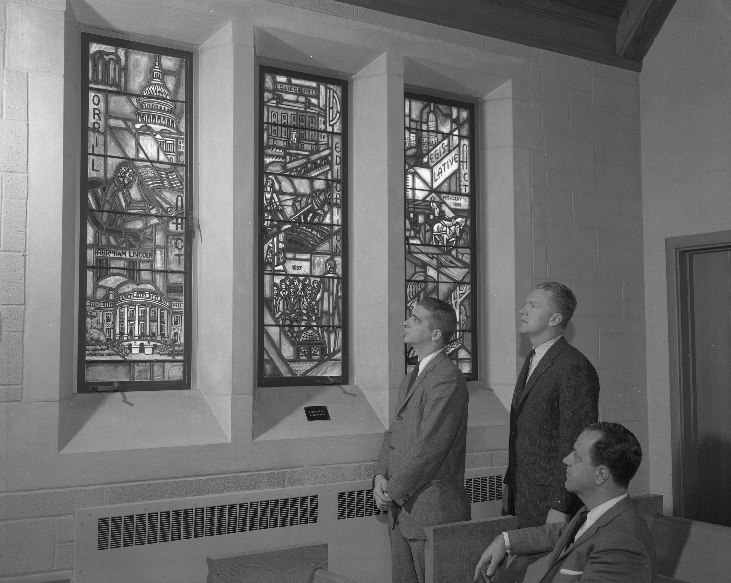 Men looking at Alumni Memorial Chapel stained glass windows; January 13, 1959