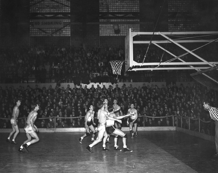 Basketball Players Looking Up at the Ball