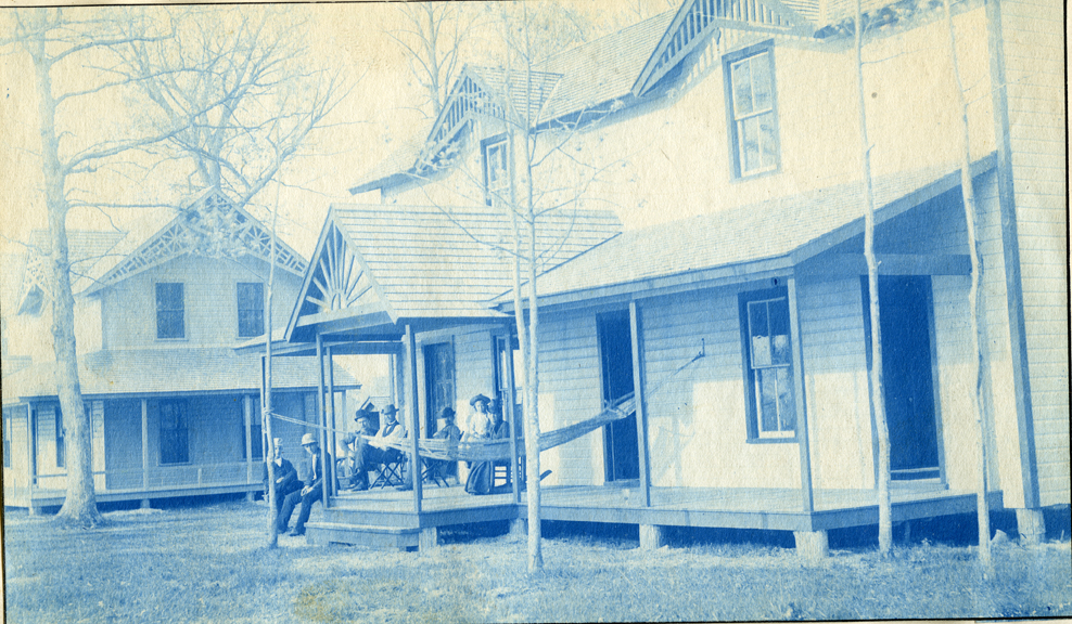 05. People sitting on the porch of a house or cottage, circa 1888.