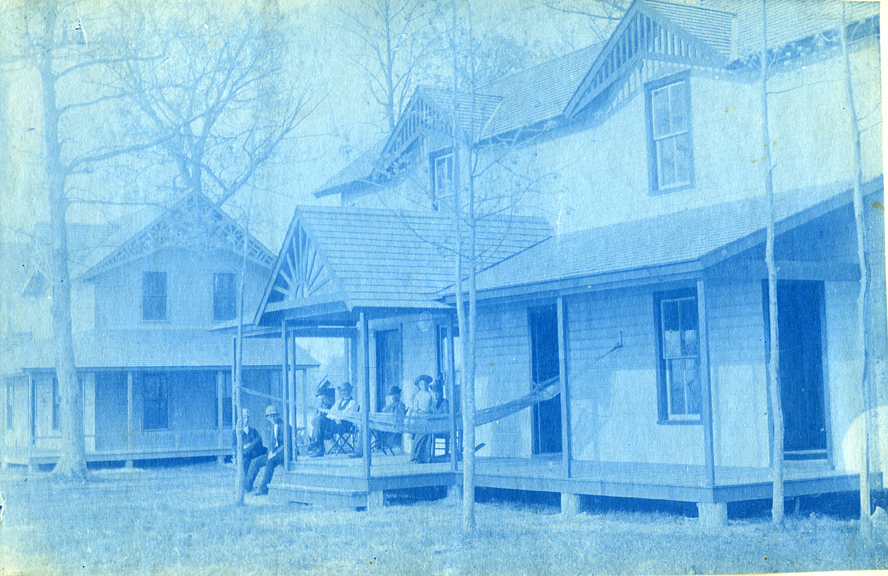 45. People sitting on the porch of a house, circa 1888.