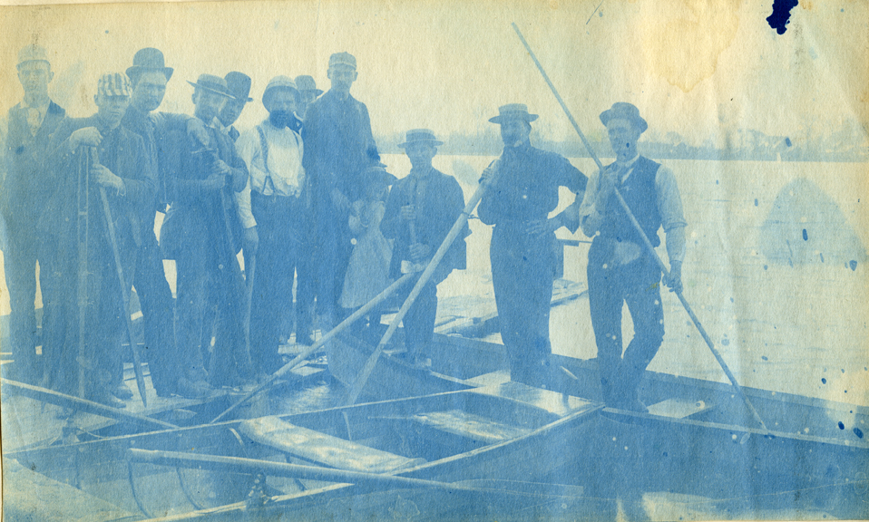57. People standing on boats, circa 1888.