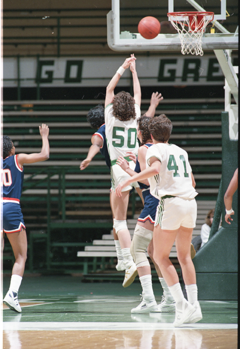Sue Tucker in air near basket, 1987