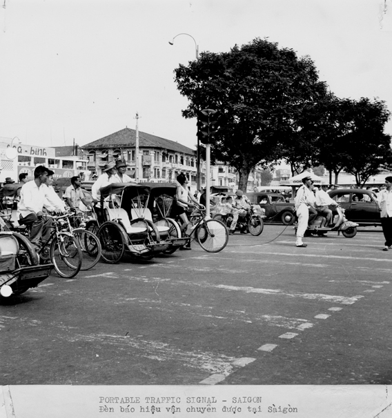 Traffic waits at a portable signal in Vietnam, 1957