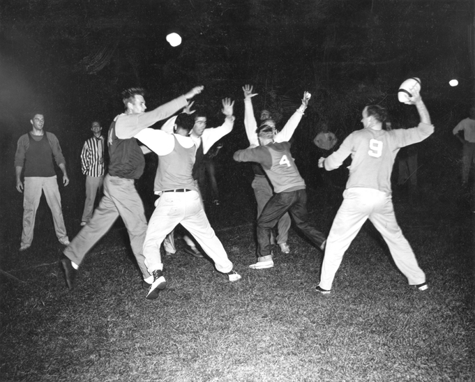 Men play football on an intramural team