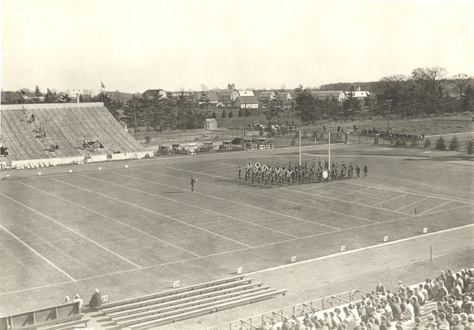 The marching band practices on the football field