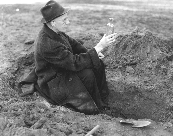 Henry Darlington unearths seeds in bottles as part of an experiment, undated