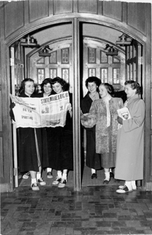 Female students reading a newspaper, ca. 1949