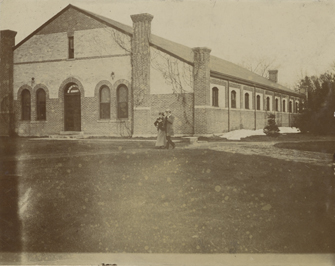 A couple walks past the Armory building