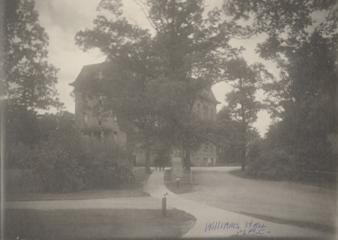 Students walking down a path from Williams Hall.