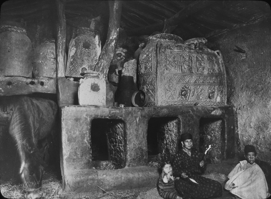 Algerian mother and children in home or stable, undated