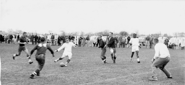 Players in action during a soccer match, 1959