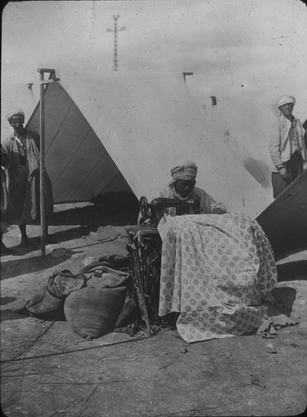 An Algerian (?) works at a sewing machine, undated