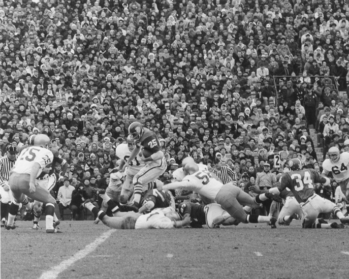 Stadium and players at a football game, 1966