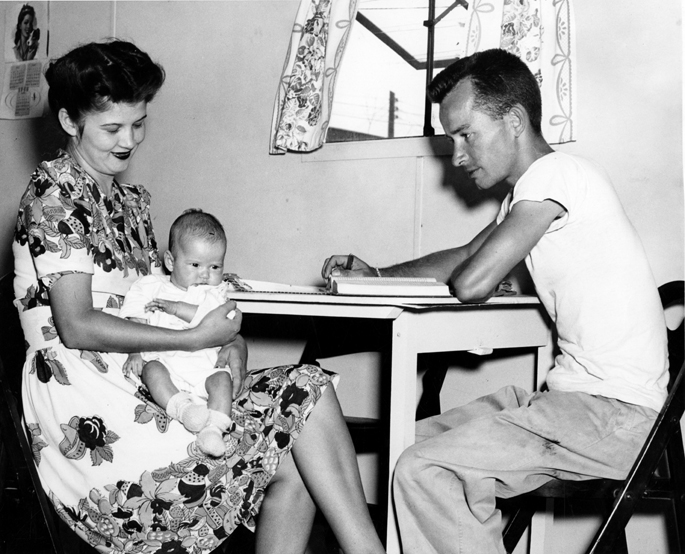 Student studying with wife and baby, 1946