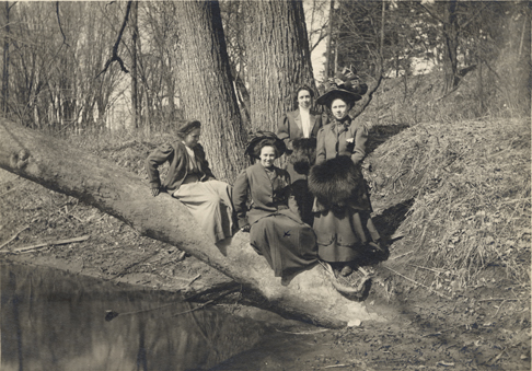 Four students on the Red Cedar, ca. 1910