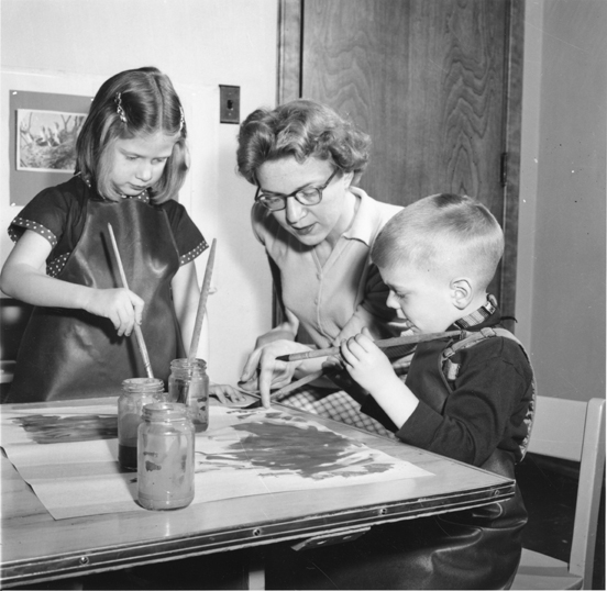 Children painting at nursery school, date unknown