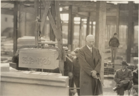 Frank Kedzie next to the cornerstone of Kedzie Hall, 1926