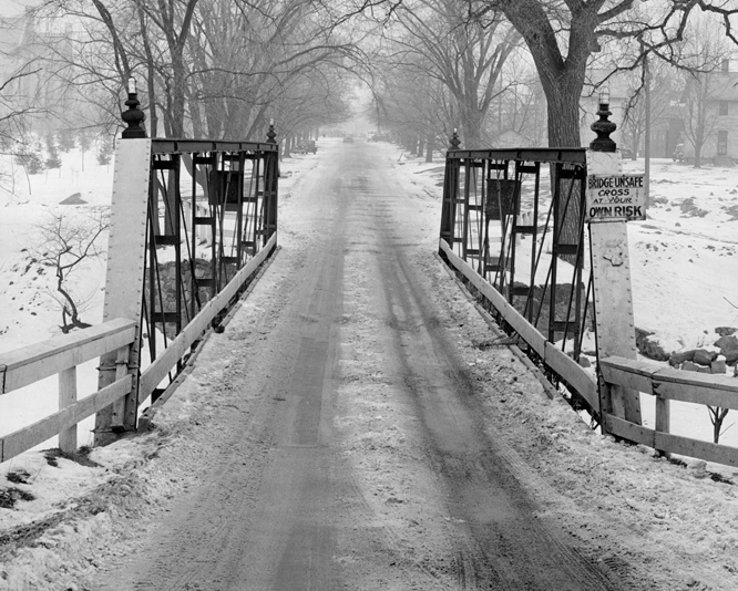 A snow covered bridge on campus, date unknown