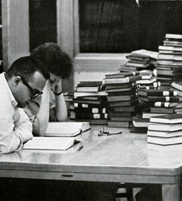 Two students reading in the library