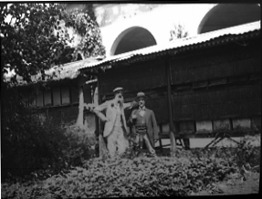 Two Men Next to Tiered Bee Hives, date unknown