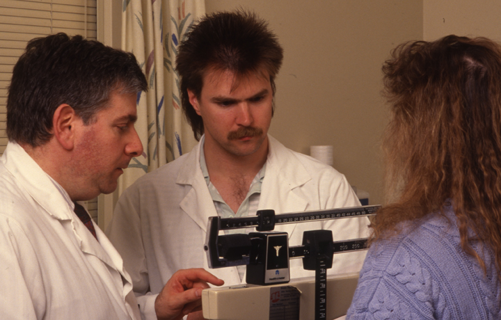 Dr. Howard Brody with unidentified CHM student and patient