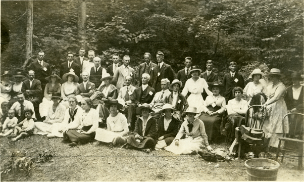 Alumni pose outdoors, undated