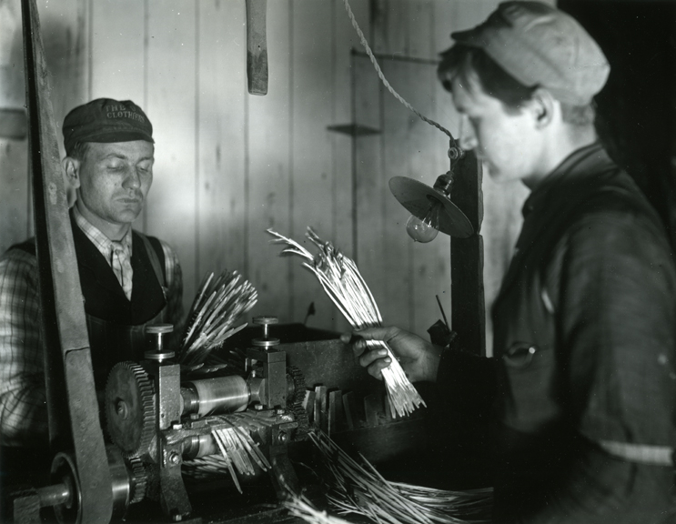 Workers mid-task at machine