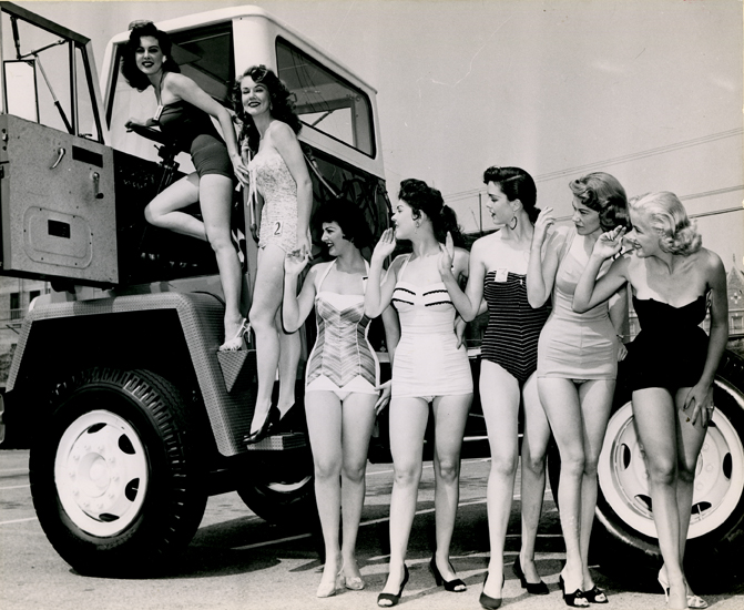 Women posing with a truck in a REO Motors advertisement, undated
