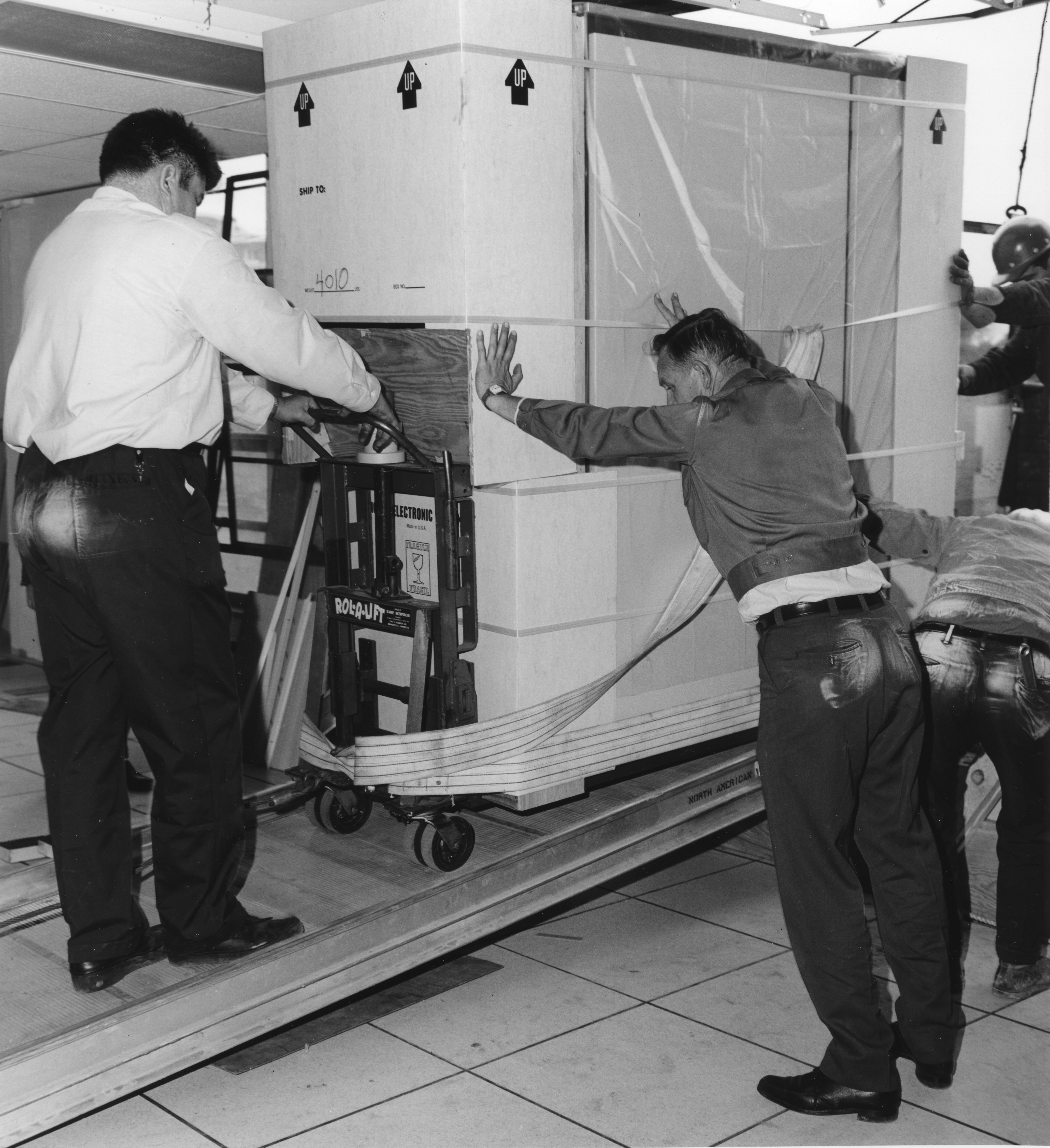 North American Van Line drivers roll equipment into Computer Center, date unknown