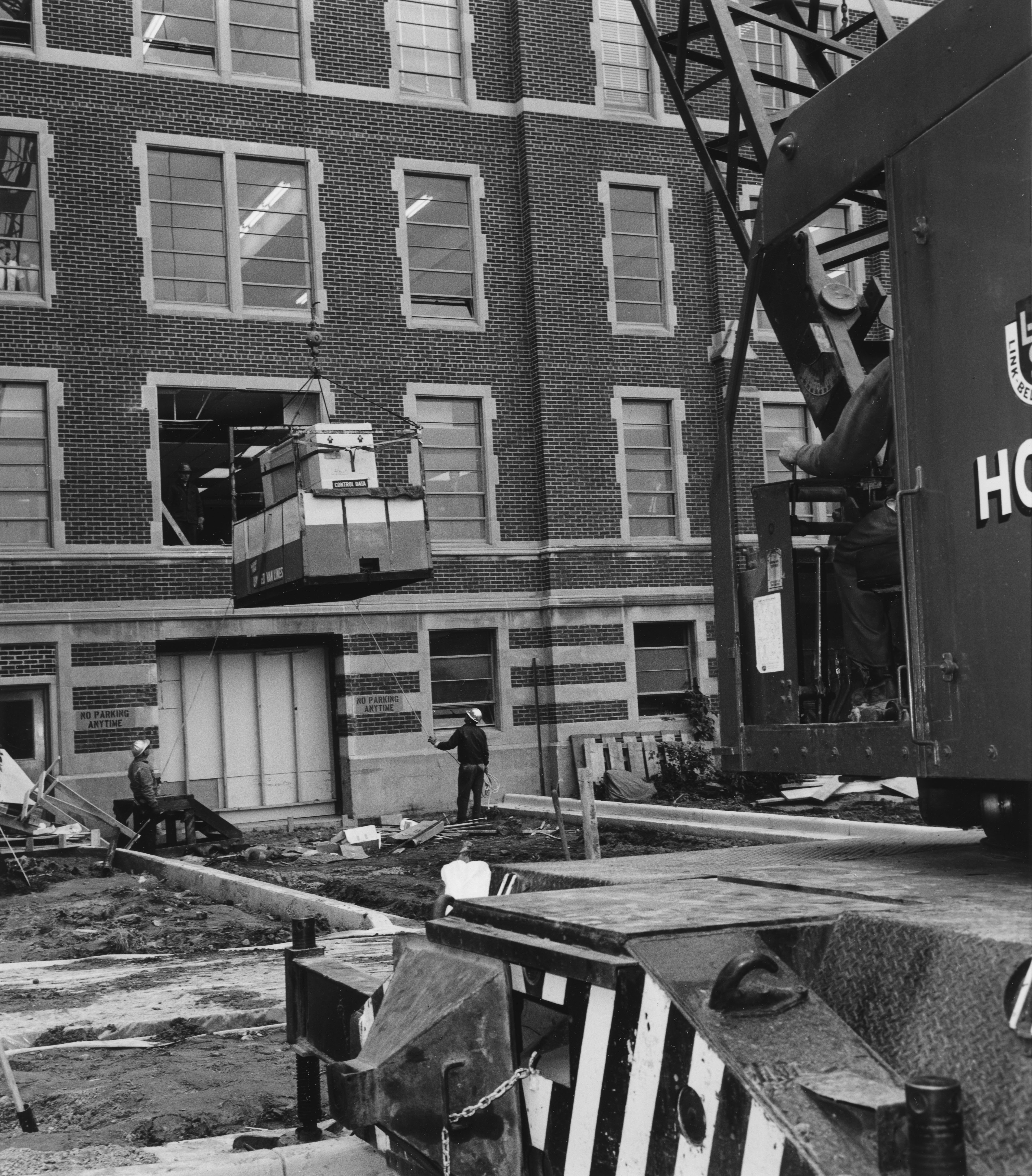 Computer lab equipment is lifted into a Computer Center window, date unknown