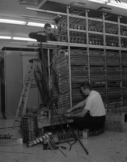 Two workers dismantle the MISTIC computer