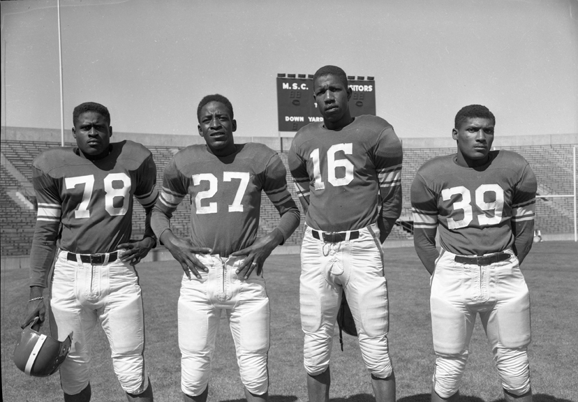 Posed Action Picture of 4 African American Football Players