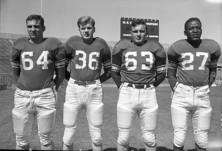 Posed Action Picture of 4 Football Players