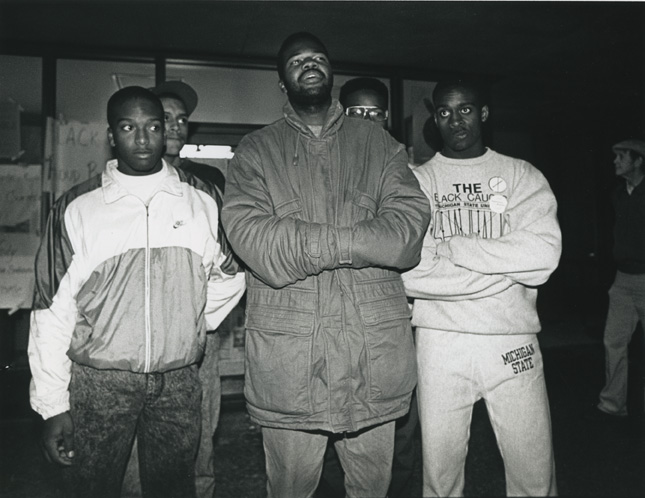 Five students stand in front of the doors of the Hannah Building during the 1989 student occupation