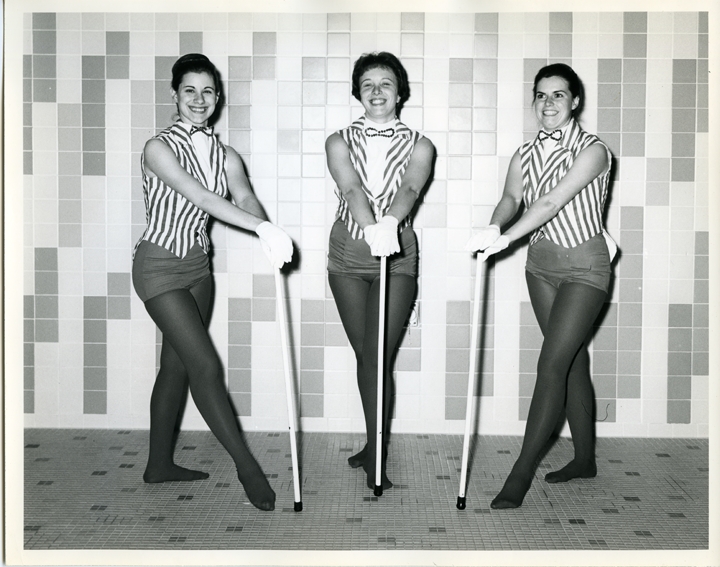 Three team members in vaudeville outfits posing