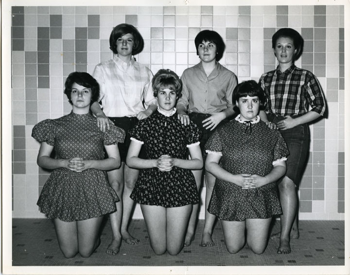 Six team members in country garb posing.