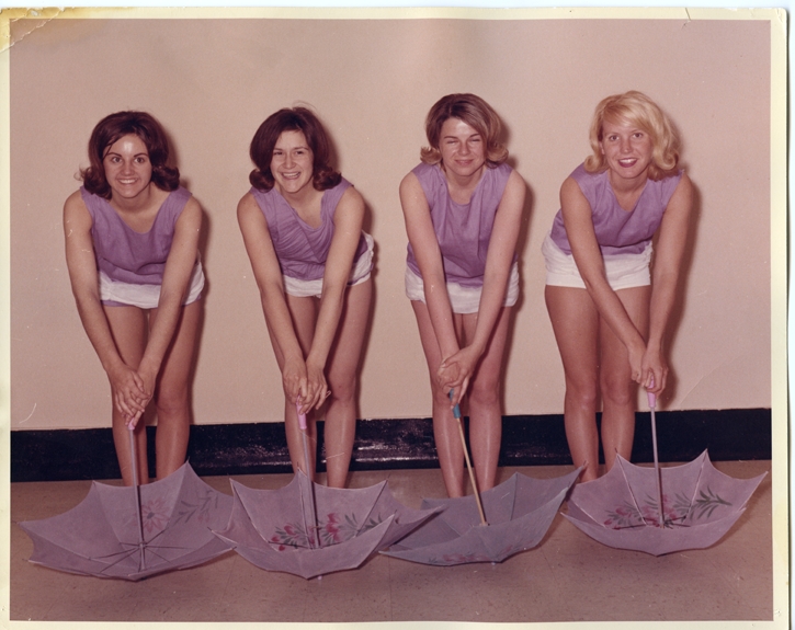 Four women posing with umbrellas