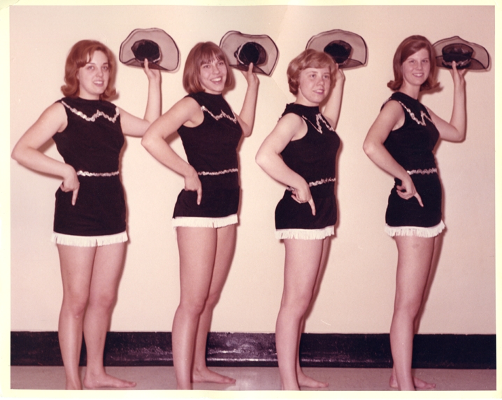 Four women in cowgirl outfits
