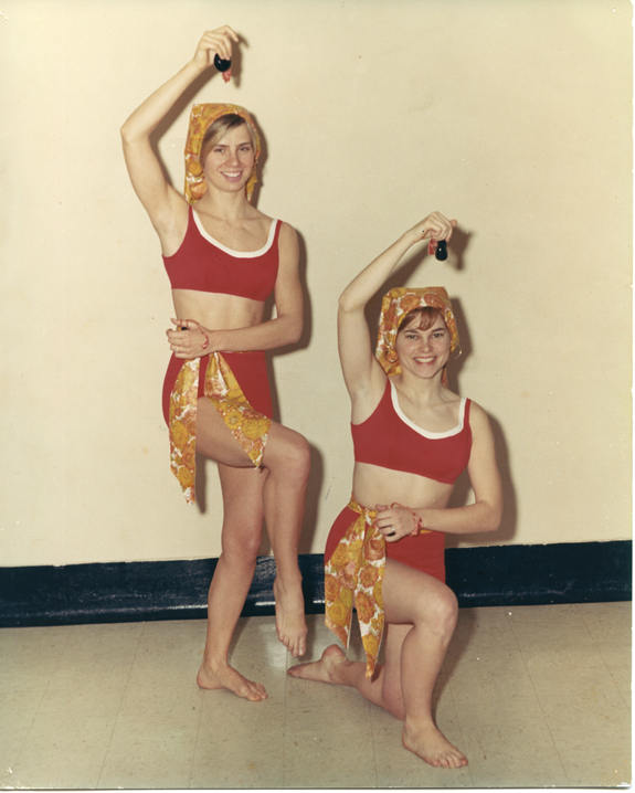 Two women in red two-piece suits posing